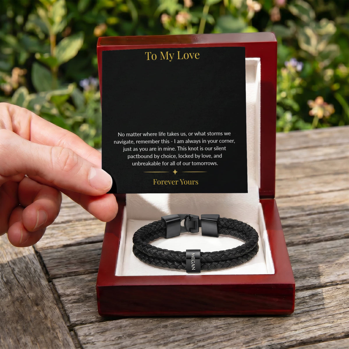 Man opening a luxury gift box featuring a personalized men's braided leather bracelet