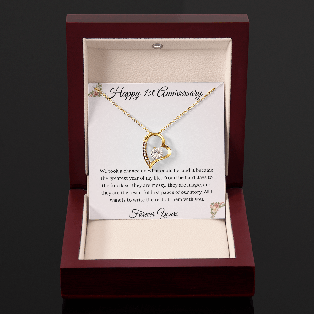 1st Anniversary gift for wife featuring a Forever Love heart necklace inside a luxury mahogany LED box. The pendant rests on a soft blush message card with blue floral corners and a romantic "messy and magic" quote
