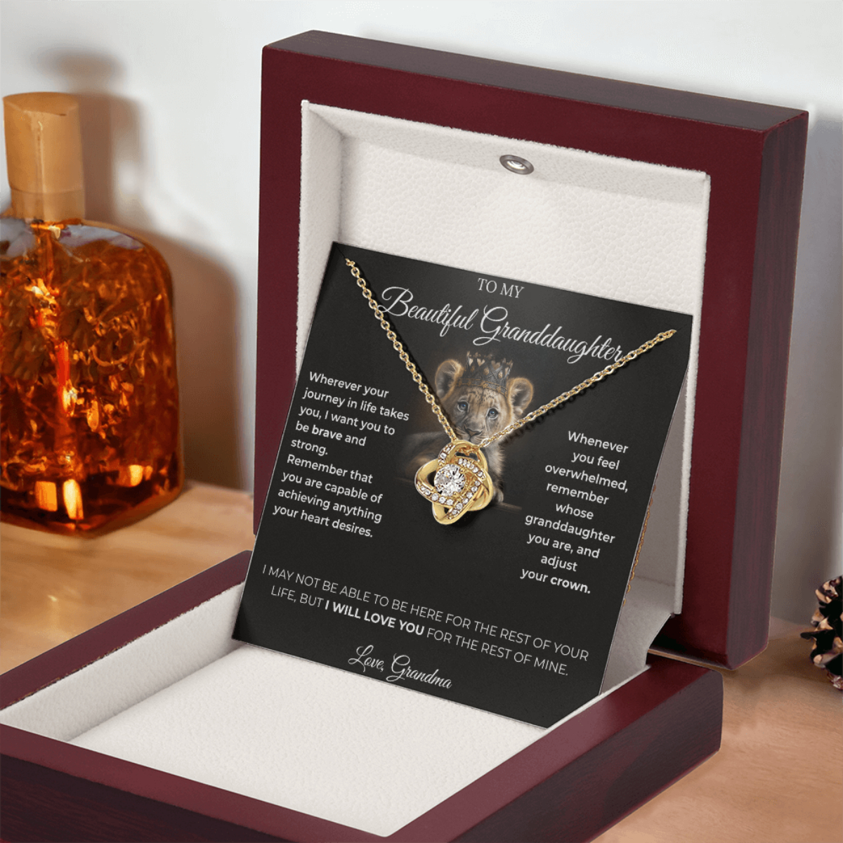 Open luxury gift box displaying the Written Affection granddaughter keepsake necklace and lion crown card