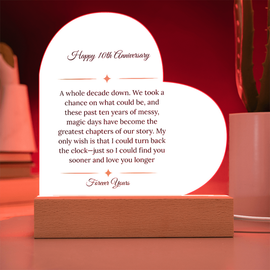 Heart shaped clear acrylic 10th anniversary gift for wife on a glowing purple LED wooden base.