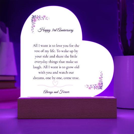 Heart shaped clear acrylic 3rd anniversary gift for wife on a glowing purple LED wooden base